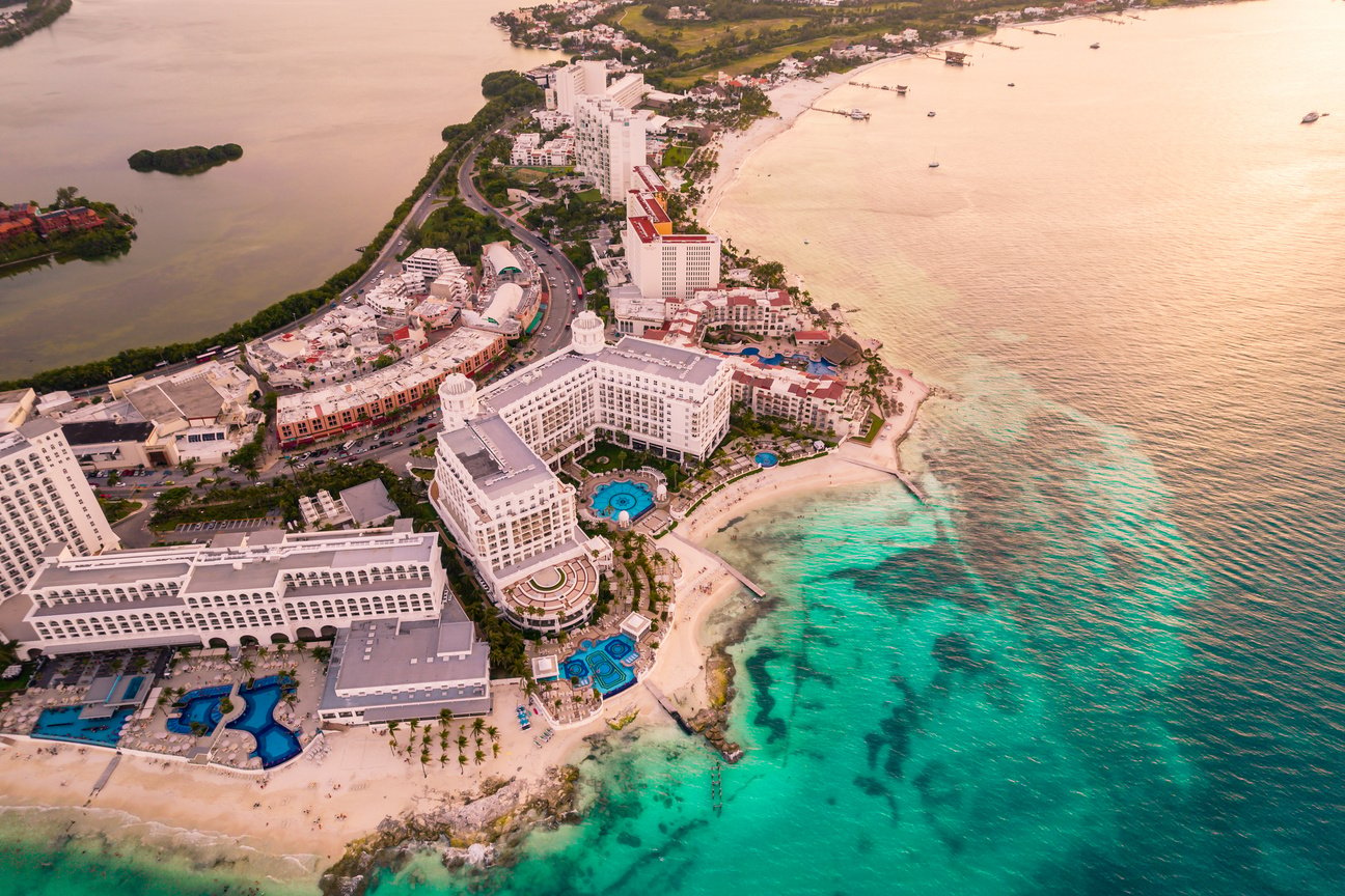 Aerial panoramic view of Cancun beach and city hotel zone in Mexico. Caribbean coast landscape of Mexican resort with beach Playa Caracol and Kukulcan road. Riviera Maya in Quintana roo region on Yucatan Peninsula